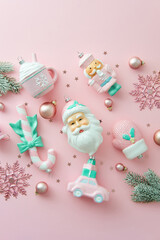 Pastel Christmas toys and decorations on light pink background. Shabby chic, cute style. Flat lay, top view