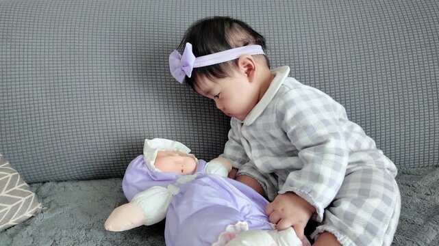 A curious baby intently observing a toy, showing early learning development and focused attention