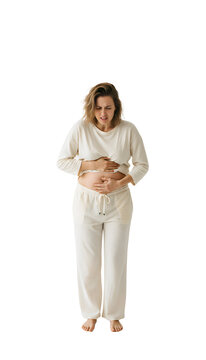 A woman looking uncomfortable holding stomach bloating