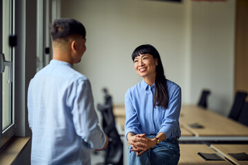 Asian Woman And Man In A Modern Office Conversation For Professional Collaboration