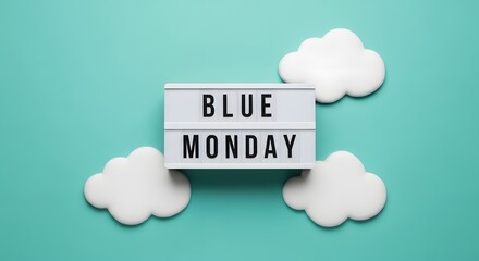 White lightbox with blue monday text surrounded by clouds words