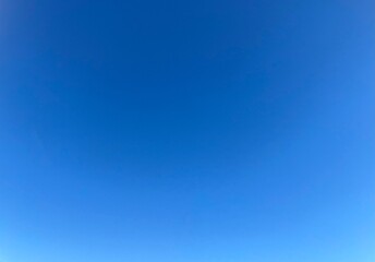 Raw unedited Spanish Iberian clear sky with light blue gradient. Morning 9am bright sunlight in Autumn. Natural, artistic, artsy and trendy sky blue background template layer. No clouds, slight halo