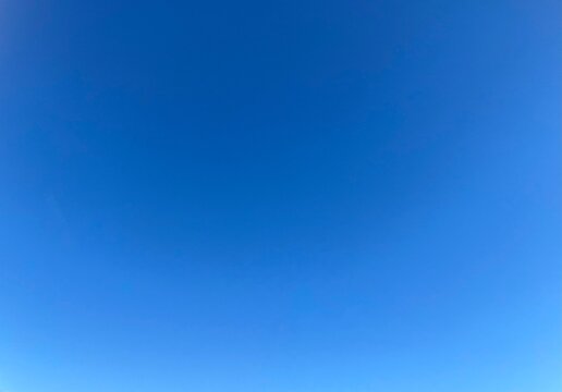Raw unedited Spanish Iberian clear sky with light blue gradient. Morning 9am bright sunlight in Autumn. Natural, artistic, artsy and trendy sky blue background template layer. No clouds, slight halo