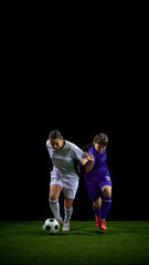 Young soccer players battling for possession with tense emotion. Concept of ball-control drills, defensive technique explanation, sports workshops, team strategy training.