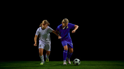 Young soccer players struggling in physical contest for ball. Concept of strength training, contact drills, competitive sport teaching, match intensity analysis.