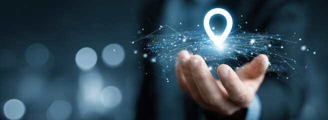 Businessman holding virtual location pin with global network connection. Logistics, navigation and digital technology concept.