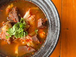 Traditional Thai noodle soup called “Nam Ngiao” This Northern Thai dish features rice noodles in a spicy and tangy tomato-based broth with pork, dried chili,