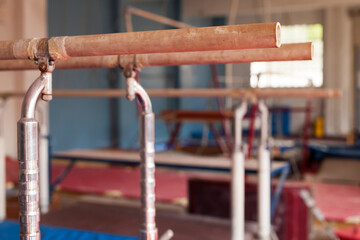 Interior of gym with old exercise machines, parallel bars and pommel horse