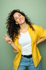 Smiling woman making peace sign gesture