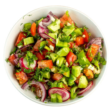 Freshly chopped vegetable salad in a white bowl top view.