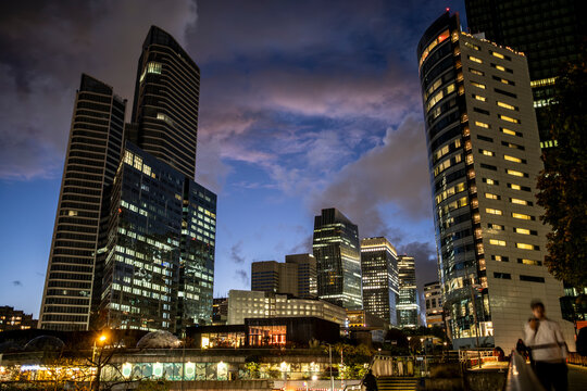 skyscraper heights defining Paris with night reflection details supporting finance and business concepts across the urban landscape characteristic of the corporate district of La Defense.