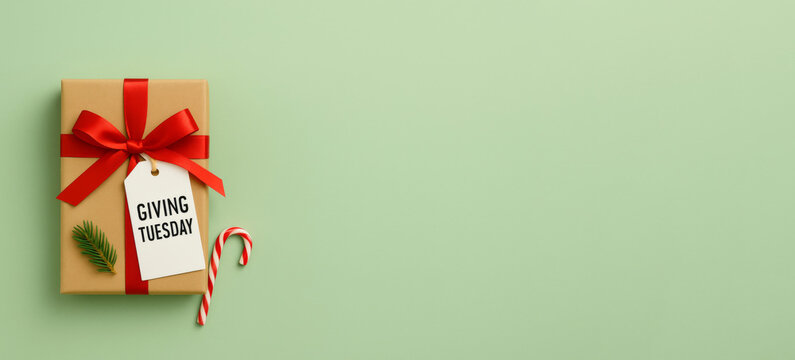 Giving Tuesday gift box with red ribbon on green background