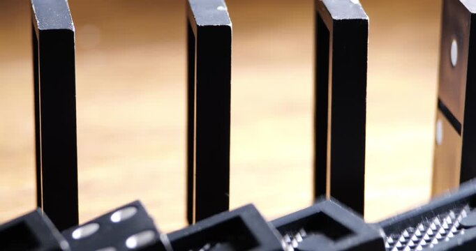 Rows Of Dominoes Falling Sequentially In Chain Reaction Demonstration Close-Up Mechanical Motion Real-Time Domino Effect For Educational Or Entertainment Purpose Sound Included 