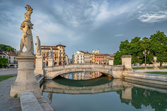 Padua, Italy. Pratto della Valle square with two rows of statues (late 18th century), an oval-shaped canal, and bridges. - Powered by Adobe