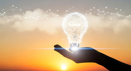 Silhouette of a hand holding a glowing digital light bulb against a dramatic sunset sky with network connections