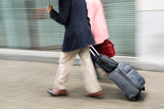 Blurred image of a man with a suitcase - Powered by Adobe