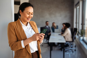 Young happy successful business woman working in corporate office