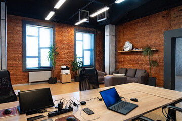 Modern office space with brick walls and stylish furniture for a productive environment