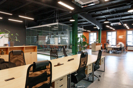 Modern coworking space with open layout and glass meeting rooms in a city
