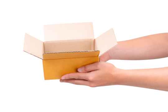 Hand holding a blank cardboard box isolated on a transparent background.