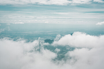 Beautiful mountain landscape with sea of mist, winding road, and resorts at Phu Thap Boek, Thailand.