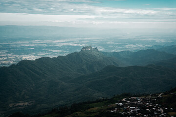 Naklejka premium Beautiful mountain landscape with sea of mist, winding road, and resorts at Phu Thap Boek, Thailand.