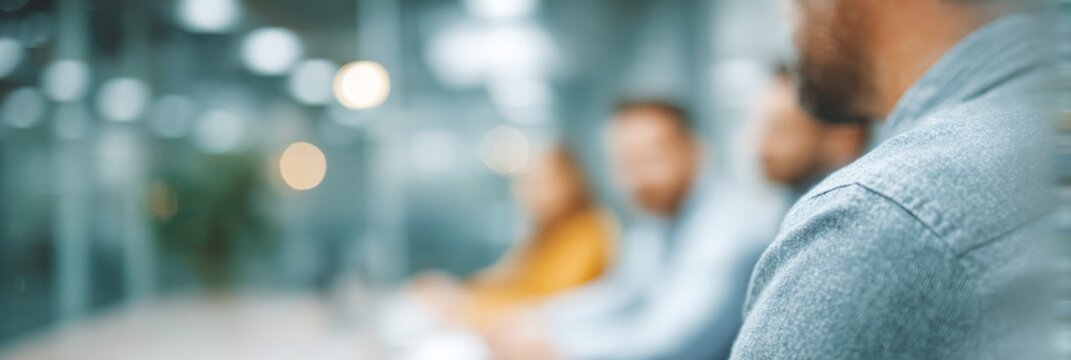 Blurry image of people sitting at a table