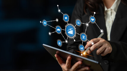 A business professional interacts with a tablet, showcasing digital analytics and connectivity symbols, emphasizing innovation and data-driven decision making in modern work environments. Tessel