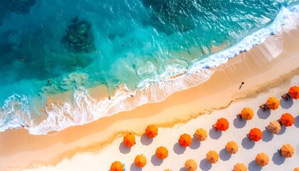 Fototapeta premium Aerial view of orange umbrellas on sandy beach with turquoise ocean waves lapping the shore on a bright day