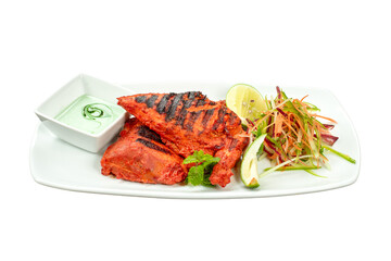 Authentic Tandoori Chicken, expertly grilled, served on a plate with fresh shredded salad, lime, and mint raita dipping sauce. Vibrant, professional studio shot for restaurant menus and food ads.