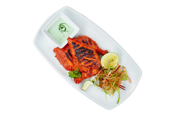 Gourmet Tandoori Chicken with mint raita and kachumber salad. Isolated, vibrant studio shot for menu design and food advertising. Authentic Indian cuisine.