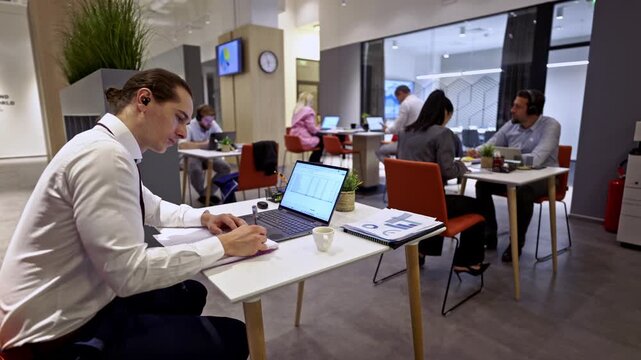 Professionals actively engaged in their daily tasks within a bright and modern open-plan business office.