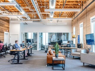 Business partners shaking hands after signing contract in modern office