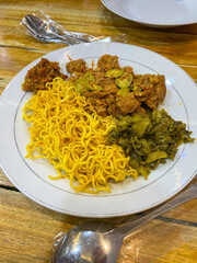 Pickled Mustard Pork Rice Mixed is food from Indonesia. Made from Pork, petai, noodles, egg, Pickled Mustard. Served on white Bowl.	
