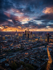 High aerial view of the illuminated City skyline of London, England, from the north towards the south during twilight