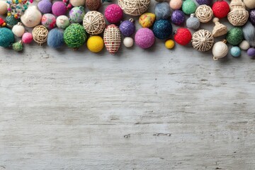 Vibrant assortment of decorative easter eggs arranged along the top edge of a rustic wooden surface