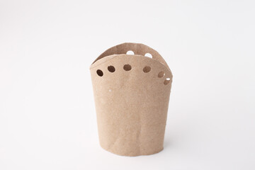 Upcycled cardboard roll with punched holes, ideal for eco craft tutorials, DIY blogs, educational content, sustainability campaigns, packaging design, creative reuse visuals.