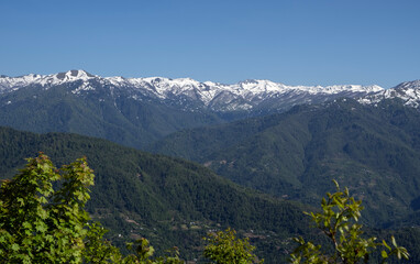 Snow-capped mountain range under clear blue sky