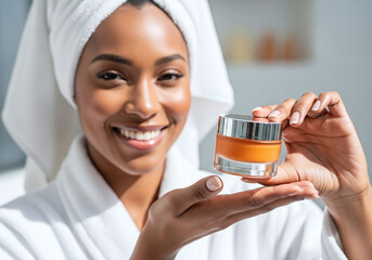 Smiling woman in bathrobe presents luxurious face cream for glowing skin, perfect for skincare product ads and beauty campaigns promoting self care rituals