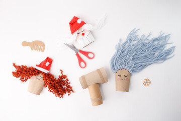 Kids handmade winter craft scene with yarn hair dolls and tools, ideal for educational centers, craft retailers, children events, seasonal marketing and DIY content platforms