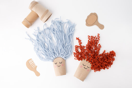 Creative recycled craft project with toilet paper rolls and cardboard accessories, ideal for educational content, DIY blogs, eco-friendly brands, kids activities, preschool marketing.
