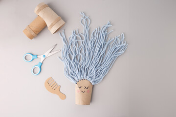 Creative recycled craft with cardboard and yarn, ideal for eco-friendly brands, DIY blogs, educational platforms, toy designers, sustainability campaigns, parenting magazines