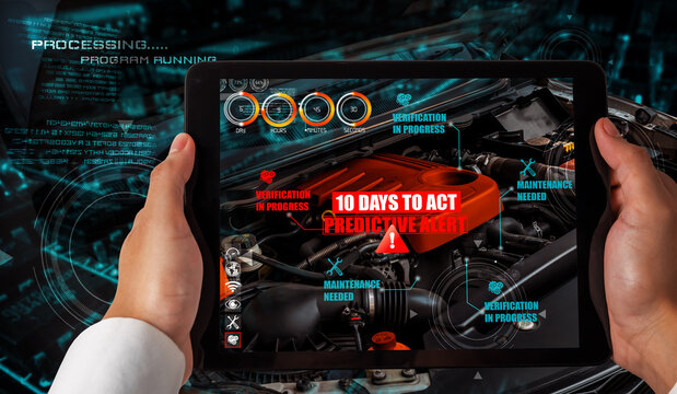 Engineer use augmented reality software to monitor parts of car vehicle with automated application . Futuristic machinery in working in concept of Industry 4.0 or 4th industrial revolution.