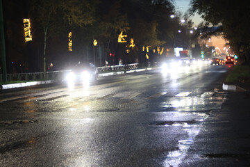 Fototapeta premium Night city blurred background, bokeh in autumn city traffic cars
