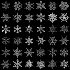 set of snowflakes on a black background, real photos natural crystals macro photo isolated on a dark background