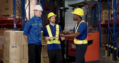 team of diverse warehouse staff including african american caucasian male supervisors discussing together near forklift holding clipboard during logistic planning inside industrial distribution center - Powered by Adobe