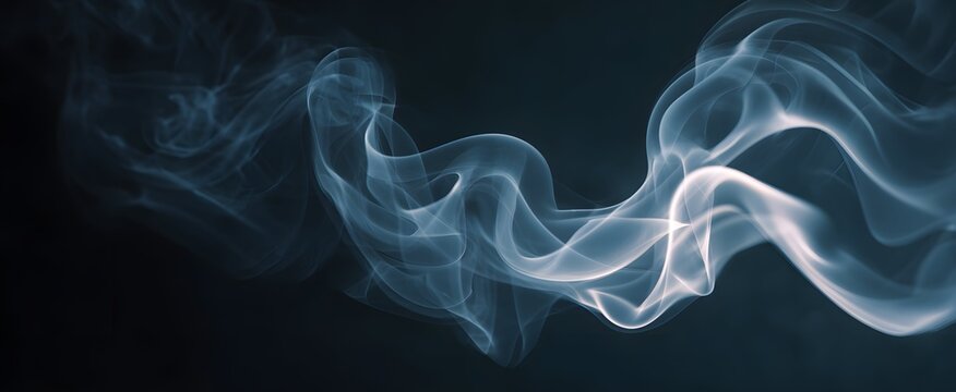 The slowly swirling smoke dances like ghostly ribbons against a dark canvas.