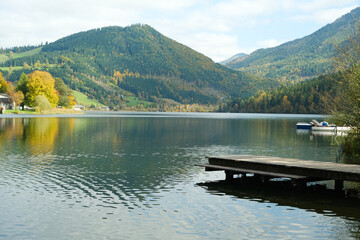 Fototapeta premium Autumn mountain landscape, mountains near lake, reflections in the water.