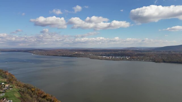 High-altitude orbit around Newburgh displaying treetops, valley lines, and river reflections emphasizing scenic outdoor travel ambience.