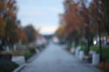 Autumn blurred background of trees in a city park, seasonal backdrop for design